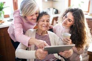 Family navigates levels of senior care looking at ipad